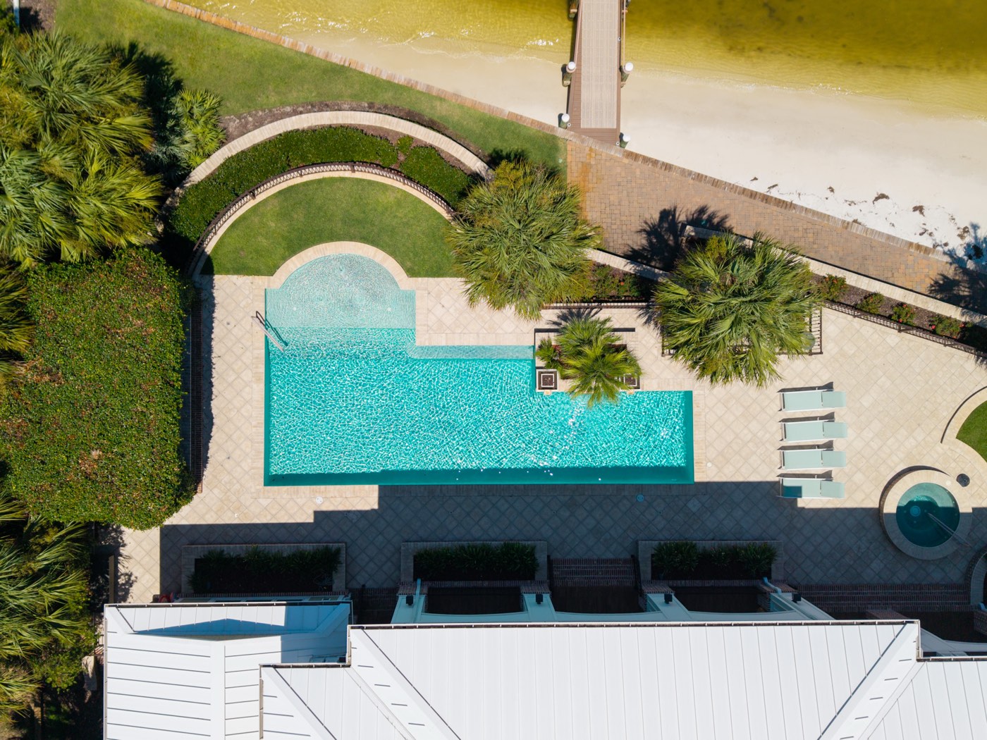 Top-down aerial view of a pool and private beach boardwalk, Ono Island