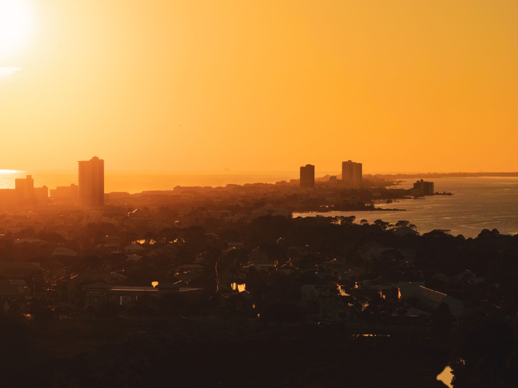 Silhouetted skyline against an orange sunset, Gulf Coast