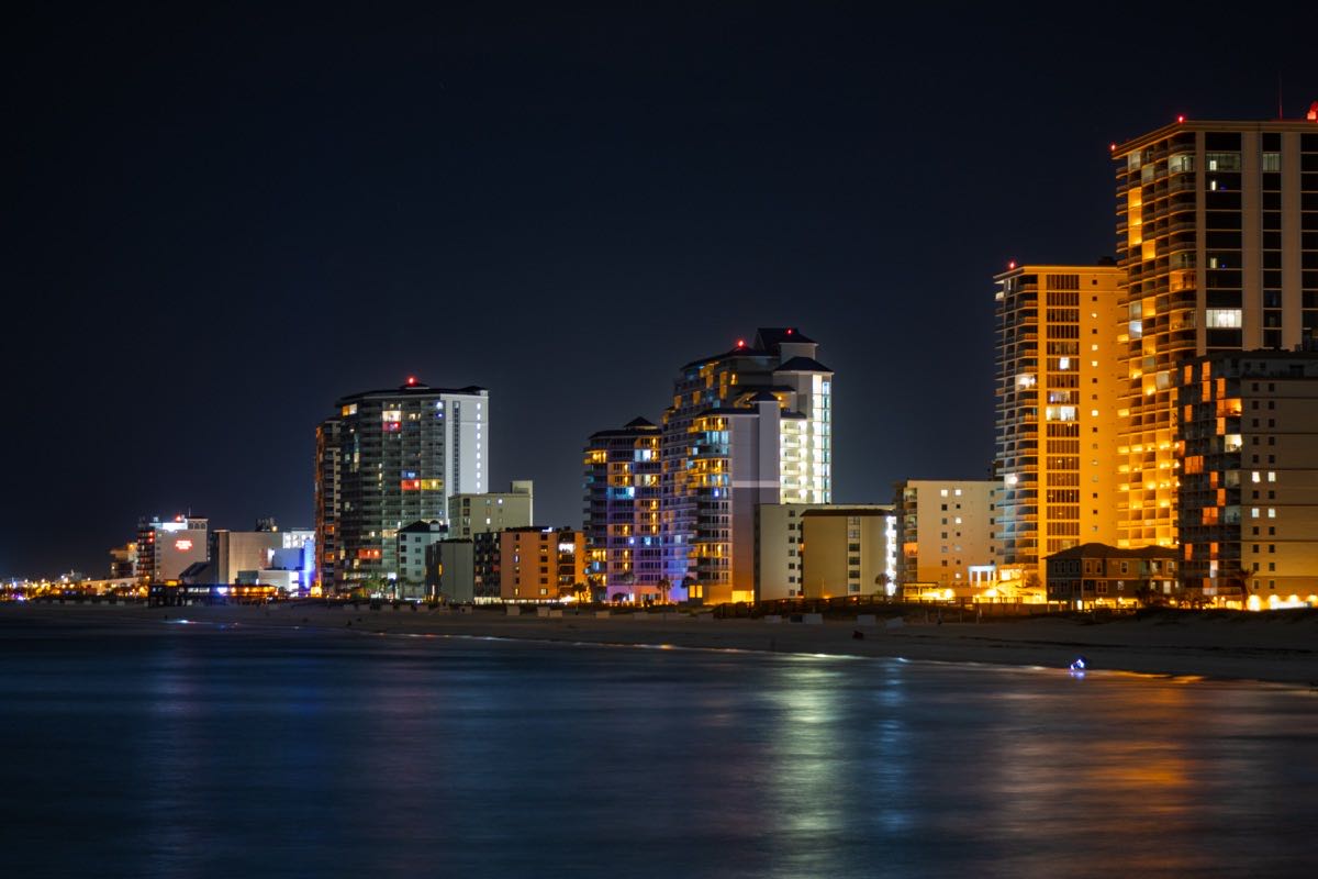 Gulf Shores skyline lit up at night from the water