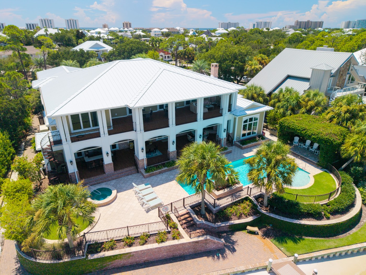 Resort-style home with curved pool, spa, and spiral staircase, aerial view, Ono Island