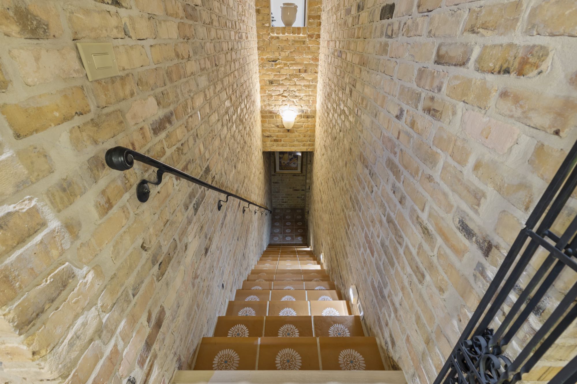 Brick vaulted stairway and hallway with wood-beamed ceiling