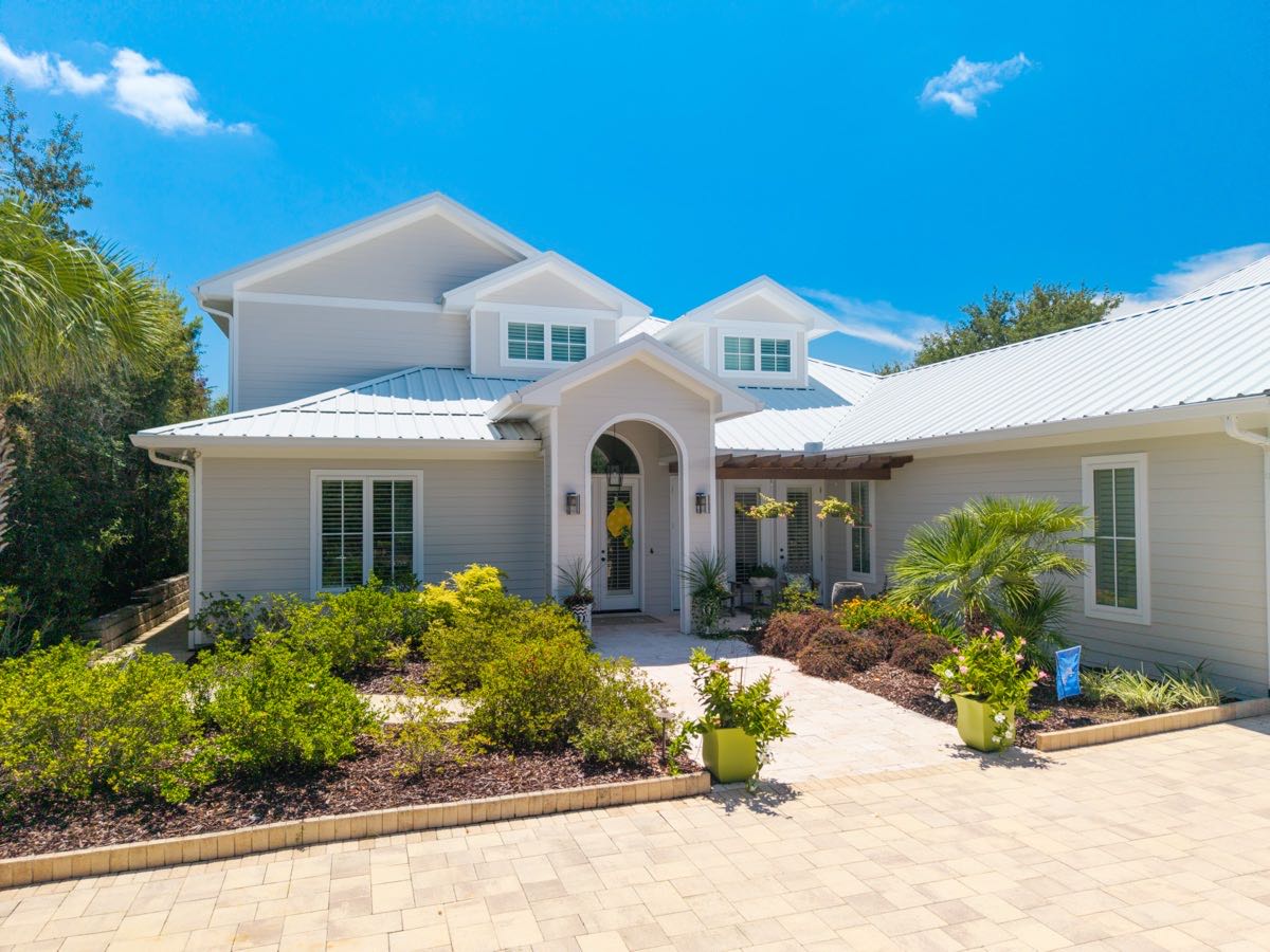 Front elevation of a modern coastal home under a clear blue sky
