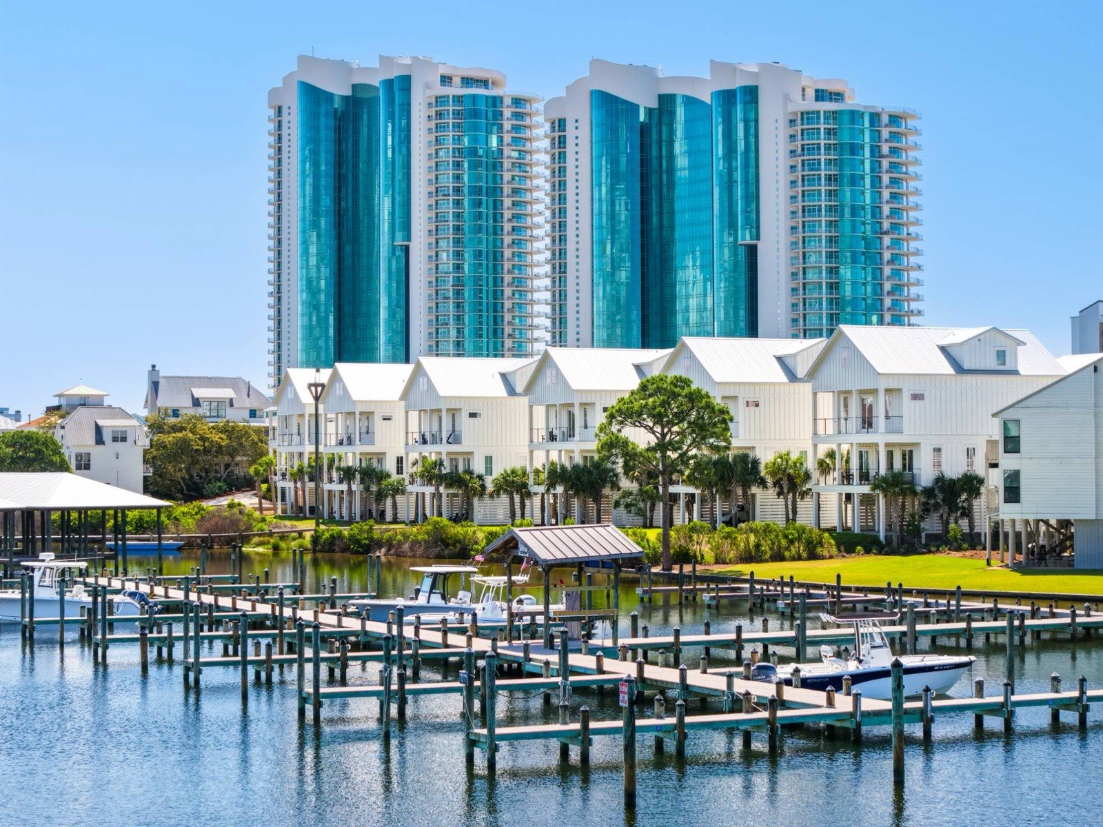 Waterfront condo towers and marina with boats docked along the water