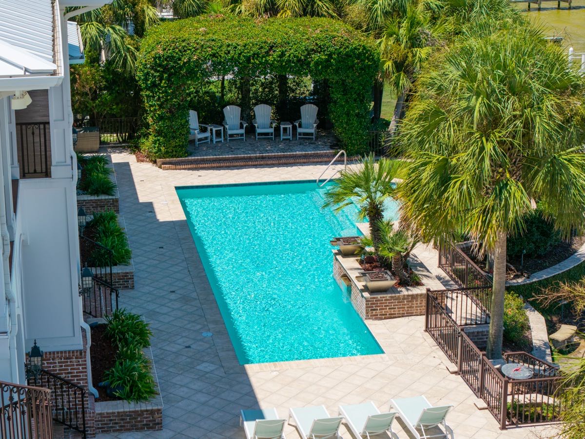 Aerial view of a resort-style pool framed by palms, Ono Island